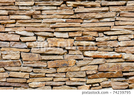 Rough masonry of the wall with orange old sandstone. 74239795