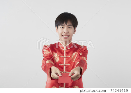 Chinese man with mandarin holding red envelope 74241419