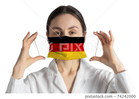 Respirator with flag of Germany Doctor puts on medical face mask isolated on white background 74242000