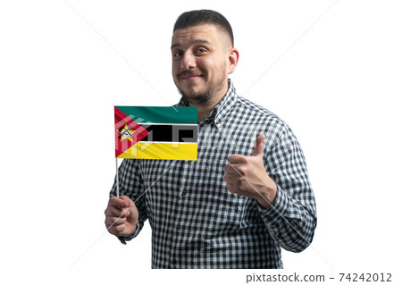 White guy holding a flag of Mozambique and shows the class by hand isolated on a white background. Like for Mozambique 74242012