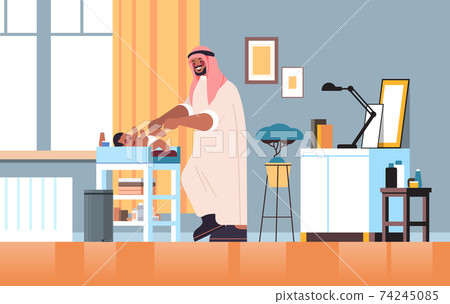 arab father changing diaper to his little son fatherhood parenting concept dad spending time with his baby arab father changing diaper to his little son fatherhood parenting concept dad spending time with his baby 74245085