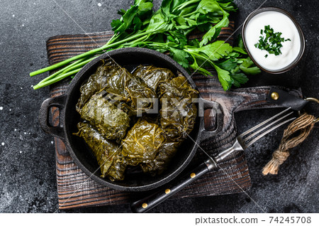 Dolma stuffed grape leaves with rice and meat. Black background. Top view 74245708