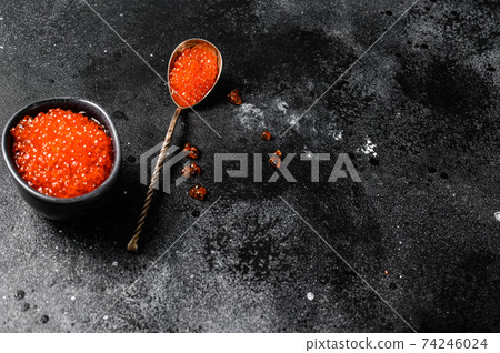 Salmon red caviar in an exquisite spoon. Black background. Top view. Copy space Salmon red caviar in an exquisite spoon. Black background. Top view. Copy space 74246024