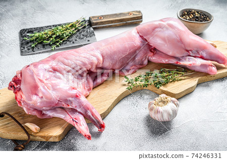 Raw hare meat on a cutting board. White background. Top view 74246331