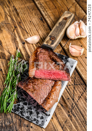 Grilled top sirloin cap beef meat steak on a cleaver. wooden background. Top view Grilled top sirloin cap beef meat steak on a cleaver. wooden background. Top view 74247228