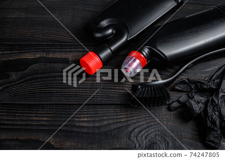Black style Home cleaning service concept with supplies. Black wooden background. Top view. Copy space Black style Home cleaning service concept with supplies. Black wooden background. Top view. Copy space 74247805