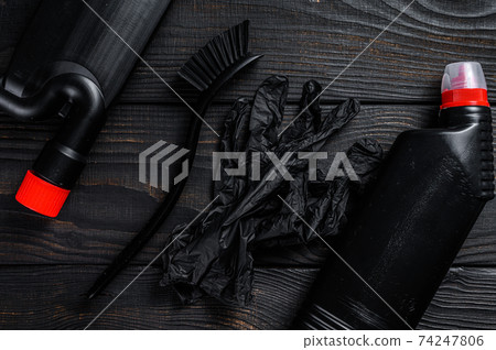 Black style Home cleaning service concept with supplies. Black wooden background. Top view Black style Home cleaning service concept with supplies. Black wooden background. Top view 74247806