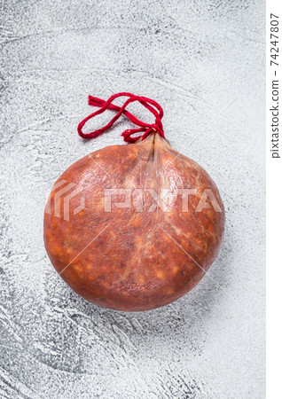 Sobrassada cured meat sausage from ground pork, paprika and spices. White background. Top view Sobrassada cured meat sausage from ground pork, paprika and spices. White background. Top view 74247807