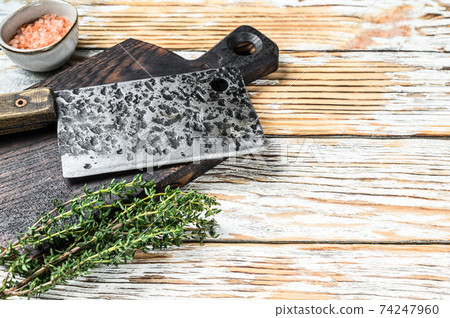 Old meat butcher cleaver. White wooden background. Top view. Copy space Old meat butcher cleaver. White wooden background. Top view. Copy space 74247960