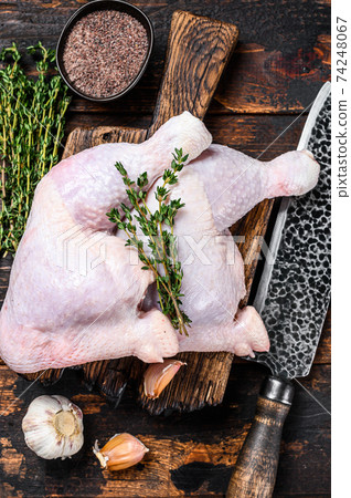 Raw chicken legs on a cutting board. Dark wooden background. Top view Raw chicken legs on a cutting board. Dark wooden background. Top view 74248067