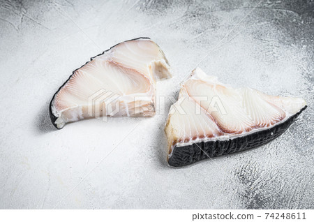 Raw Shark fish steaks on a kitchen table. White background. Top view Raw Shark fish steaks on a kitchen table. White background. Top view 74248611