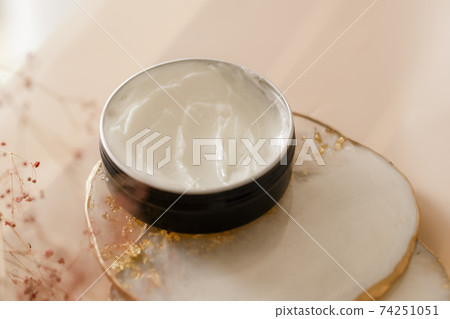 Cosmetic cream texture in a jar on pastel background Cosmetic cream texture in a jar on pastel background 74251051