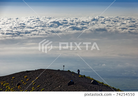 Climbers and sea of clouds near Mt. Fuji and Hoei crater 74254550