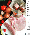 fresh, raw pork entrecote on a board, spices and vegetables. 74255994