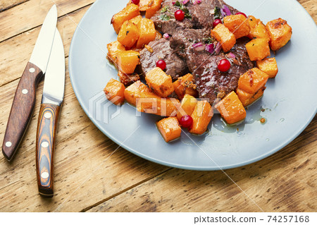 Beef stew with pumpkin on wooden table Beef stew with pumpkin on wooden table 74257168