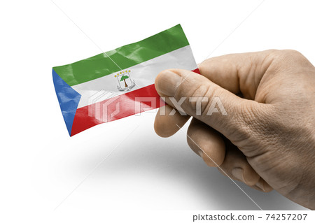Hand holding a card with a national flag the Equatorial Guinea Hand holding a card with a national flag the Equatorial Guinea 74257207