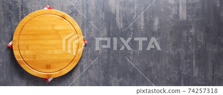 Pizza cutting board and cloth napkin on stone surface of table Pizza cutting board and cloth napkin on stone surface of table 74257318