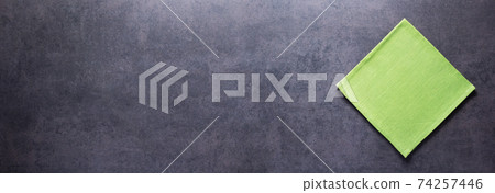 Folded tablecloth at stone or marble surface of table. Cloth napkin texture background 74257446