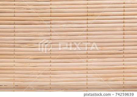 Background bamboo sticks with thread uniting. Asian style bamboo brown straw weave rug. Background bamboo sticks with thread uniting. Asian style bamboo brown straw weave rug. 74259639