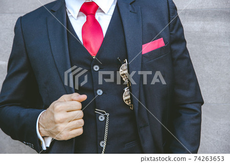 Gentle uniform stylish tuxedo luxury suit with red necktie for modern groom or fashionable business person 74263653