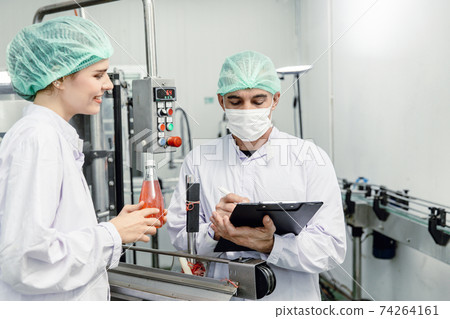 Food and drink factory ISO audit quality control team working, hygiene check and process standard inspection in plant production line. Food and drink factory ISO audit quality control team working, hygiene check and process standard inspection in plant production line. 74264161