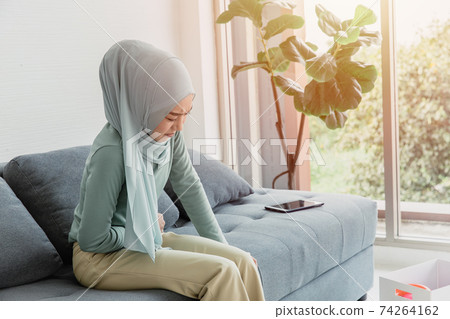 arab women stomach ache serious cramps, abdominal pain from menstruation or period health problem expression arab women stomach ache serious cramps, abdominal pain from menstruation or period health problem expression 74264162