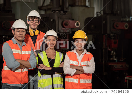 Group of Team Worker mix race enjoy working in heavy factory standing together happy smiling Group of Team Worker mix race enjoy working in heavy factory standing together happy smiling 74264166