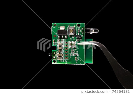 Internet of Things (IoT) system on a chip (SOC) integrated circuit computer with small microchip microcontroller isolated on black background. 74264181