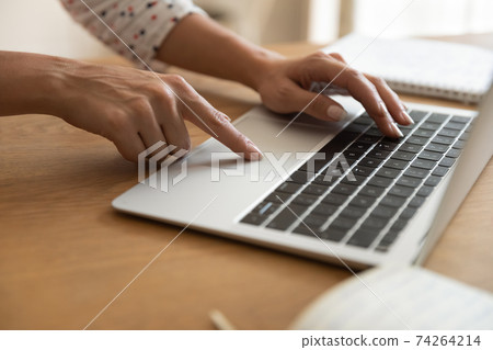 Close up of woman work distant on laptop gadget Close up of woman work distant on laptop gadget 74264214