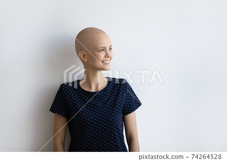 Happy female cancer patient look in distance dreaming 74264528