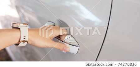 Hand holding the car handle and opening a door,  Transport, service and rental concept 74270836