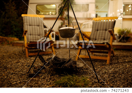 Pot is over campfire, picnic at camping, nobody Pot is over campfire, picnic at camping, nobody 74271243