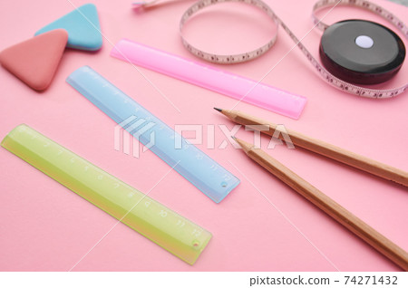 Stationery supplies closeup, pink background Stationery supplies closeup, pink background 74271432