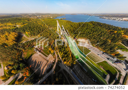Aerial panoramic view of Lahti sports centre with three ski jump towers. 74274052