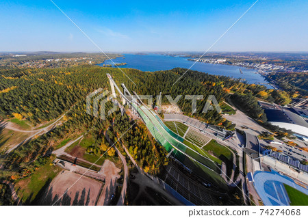 Aerial panoramic view of Lahti sports centre with three ski jump towers. Aerial panoramic view of Lahti sports centre with three ski jump towers. 74274068