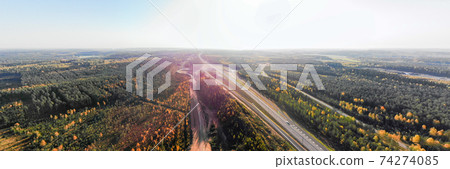 Aerial panoramic view of the road and forest in Finland 74274085