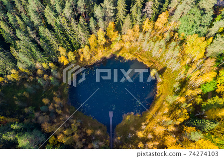 Aerial view of small forest lake Haransilma in Lahti, Finland. The diameter of lake is about 50 m. 74274103