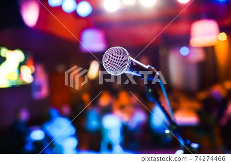 Microphone on stage against a background of auditorium. Microphone on stage against a background of auditorium. 74274466