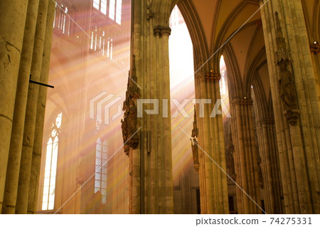 Light from stained glass inside Cologne Cathedral 74275331