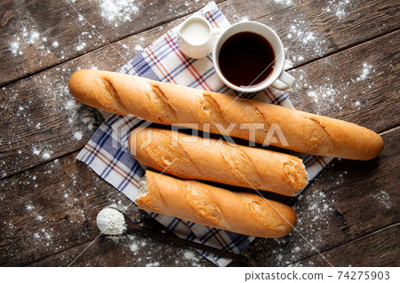 Several french baguettes with coffee and milk Several french baguettes with coffee and milk 74275903