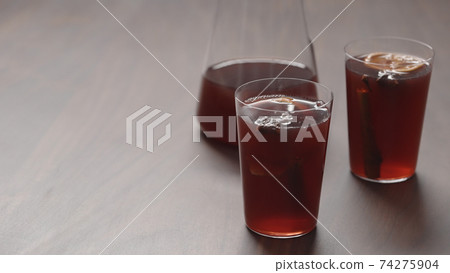mulled wine in thin tumbler glasses on walnut table mulled wine in thin tumbler glasses on walnut table 74275904