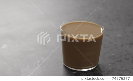 milk coffee in glass on concrete countertop milk coffee in glass on concrete countertop 74276277