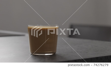 milk coffee in glass on concrete countertop milk coffee in glass on concrete countertop 74276279
