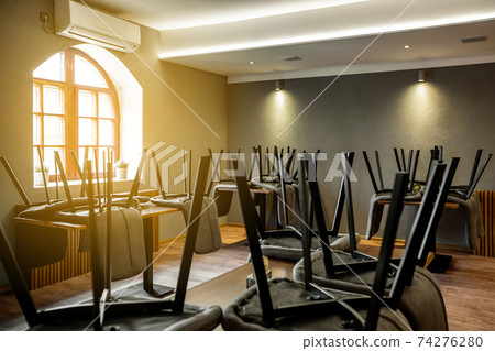 View to closed restaurant or pub without people during coronavirus pandemic, covid-19, lockdown concept, economic crisis View to closed restaurant or pub without people during coronavirus pandemic, covid-19, lockdown concept, economic crisis 74276280