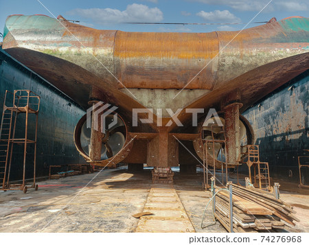 Industry view - Ocean Vessel in the dry dock in shipyard. Old rusty ship under repair 74276968