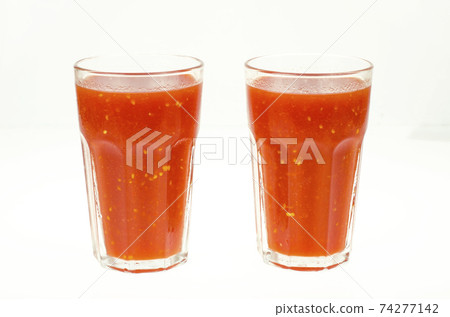 Natural tomato juice in glass on white background. Natural tomato juice in glass on white background. 74277142