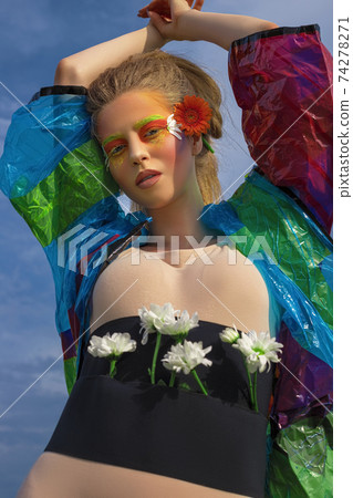 Portrait of a young, beautiful, white, woman with a hairstyle and creative art make-up 74278271