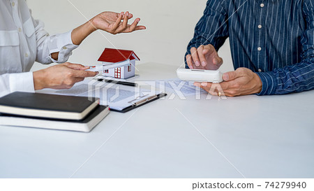 Real estate agent and customer signing contract to buy house, insurance or loan real estate. Real estate agent and customer signing contract to buy house, insurance or loan real estate. 74279940