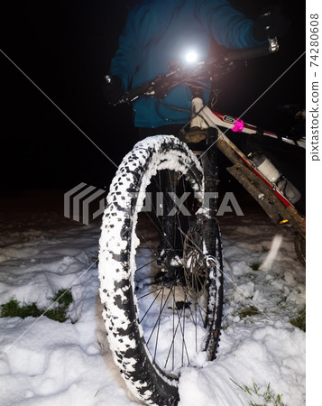 Extreme race in snow. Boy pushing mtb after accident on slippery ground Extreme race in snow. Boy pushing mtb after accident on slippery ground 74280608