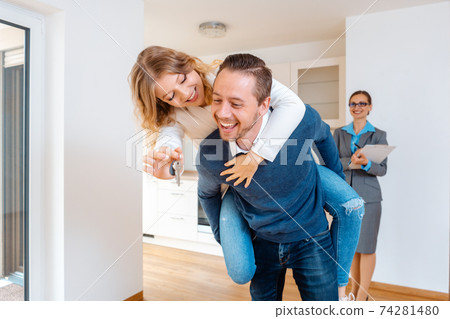 Woman and man being extremely happy about their new home Woman and man being extremely happy about their new home 74281480